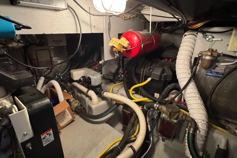 Comfort Zone Yacht Photos Pics Engine room of 2005 Meridian 368 Motoryacht with hoses, wires, and fire extinguisher.