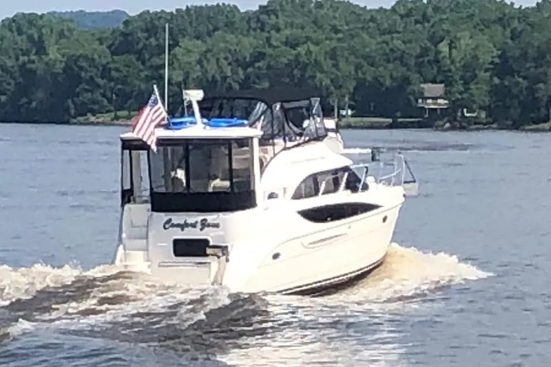 Comfort Zone Yacht Photos Pics 2005 Meridian 368 Motoryacht cruising on a river with lush green trees.