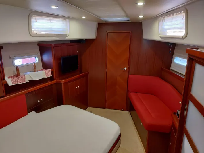 Felitsata II Yacht Photos Pics Luxurious interior of 2011 Hanse 62 DS yacht with red accents and modern amenities.