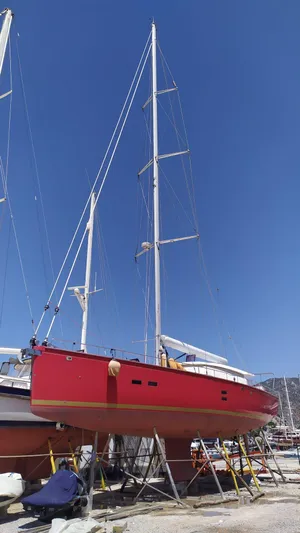Felitsata II Yacht Photos Pics Red 2011 Hanse 62 DS sailboat on dry dock under clear blue sky.