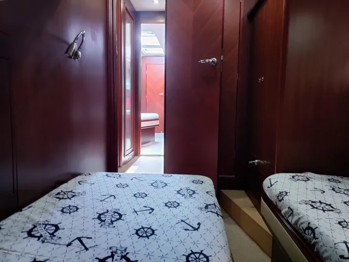 Felitsata II Yacht Photos Pics Cabin interior of 2011 Hanse 62 DS yacht with nautical-themed bedding.