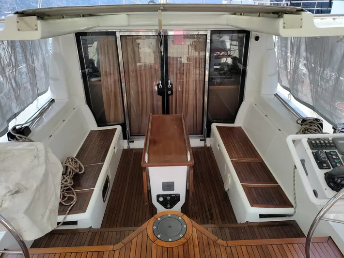 Felitsata II Yacht Photos Pics 2011 Hanse 62 DS yacht cockpit with wooden seating and table.
