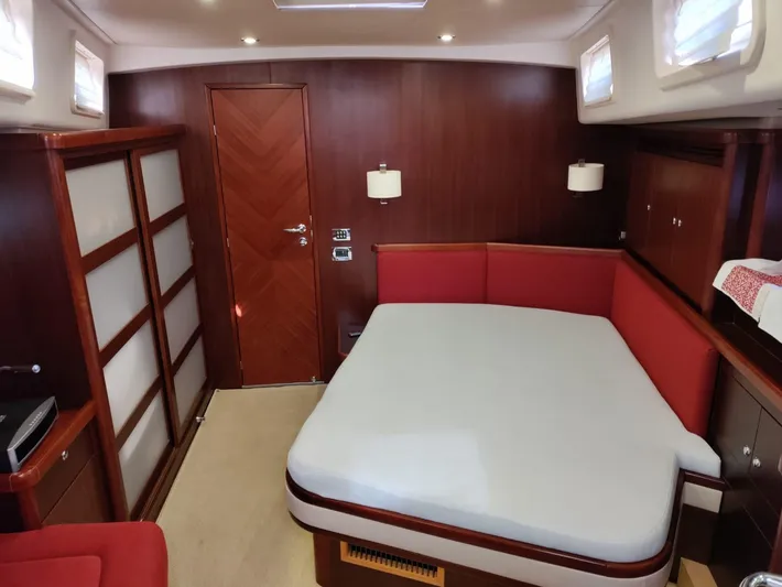 Felitsata II Yacht Photos Pics Luxurious cabin interior of 2011 Hanse 62 DS yacht with wood paneling and red accents.