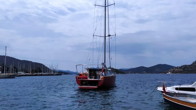 Felitsata II Yacht Photos Pics Sailing yacht Hanse 62 DS (2011) on calm waters with mountainous backdrop.
