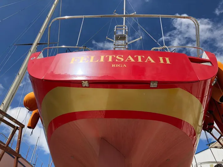 Felitsata II Yacht Photos Pics Red Hanse 62 DS yacht, named "Felitsata II," docked under a clear blue sky.