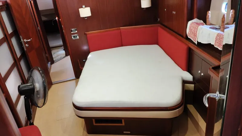 Felitsata II Yacht Photos Pics Luxurious cabin interior of 2011 Hanse 62 DS yacht with red accents and modern amenities.