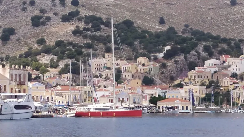 Felitsata II Yacht Photos Pics Sailboat Hanse 62 DS (2011) docked in a picturesque coastal village harbor.