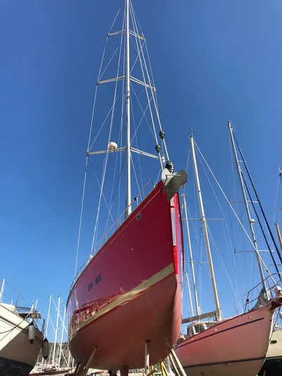 Felitsata II Yacht Photos Pics Red 2011 Hanse 62 DS sailboat on land, clear blue sky background.