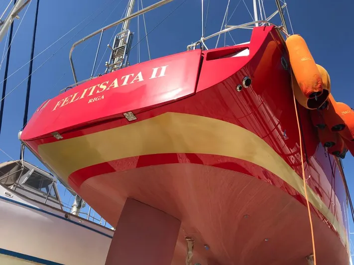Felitsata II Yacht Photos Pics Red and yellow Hanse 62 DS yacht, 2011 model, docked with visible lifebuoys.