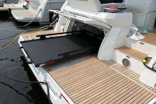  Yacht Photos Pics 2022 Jeanneau Leader 46 yacht with open storage compartment and teak deck.