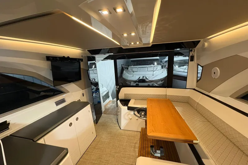  Yacht Photos Pics Luxurious interior of 2022 Jeanneau Leader 46 yacht with modern seating and wooden table.