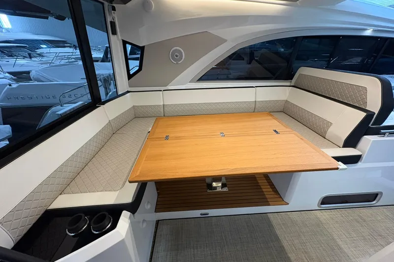  Yacht Photos Pics Interior of 2022 Jeanneau Leader 46 yacht with elegant seating and wooden table.