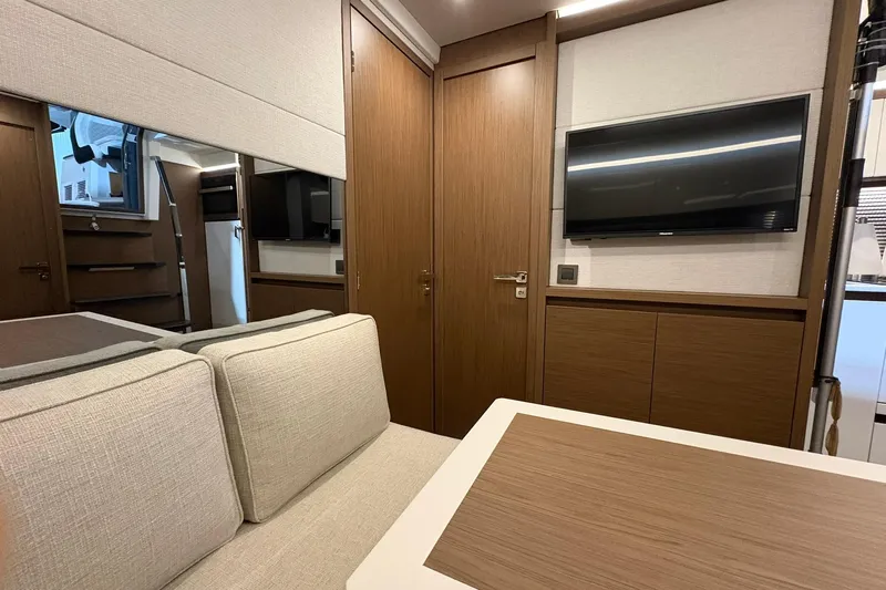 Yacht Photos Pics Interior of 2022 Jeanneau Leader 46 yacht with modern furnishings and TV.