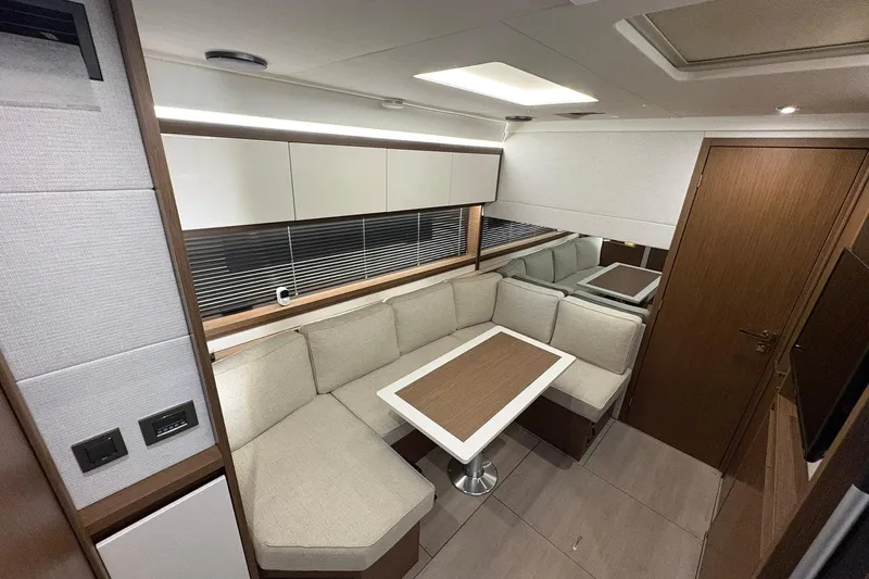  Yacht Photos Pics Interior of 2022 Jeanneau Leader 46 yacht with modern seating and dining area.