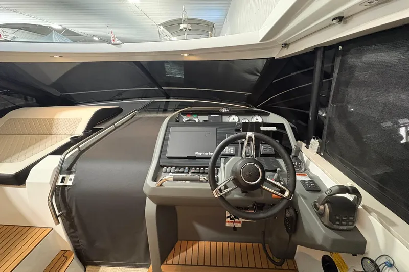  Yacht Photos Pics 2022 Jeanneau Leader 46 cockpit with modern steering and navigation controls.