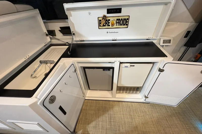  Yacht Photos Pics 2022 Jeanneau Leader 46 yacht kitchen with sink, fridge, and storage compartments.