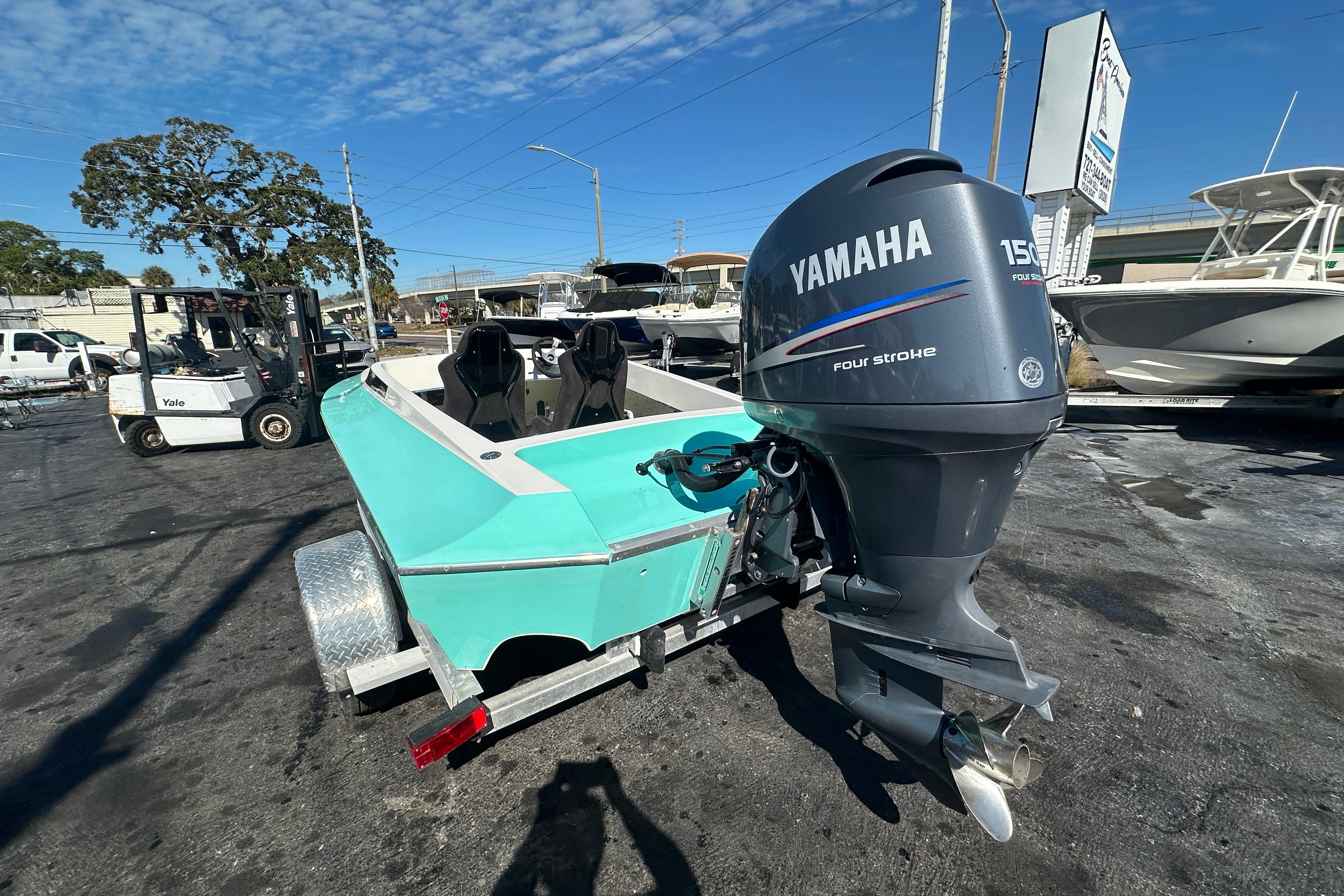 2022 Lightning 18 boat with Yamaha 150 outboard motor in a marina setting.