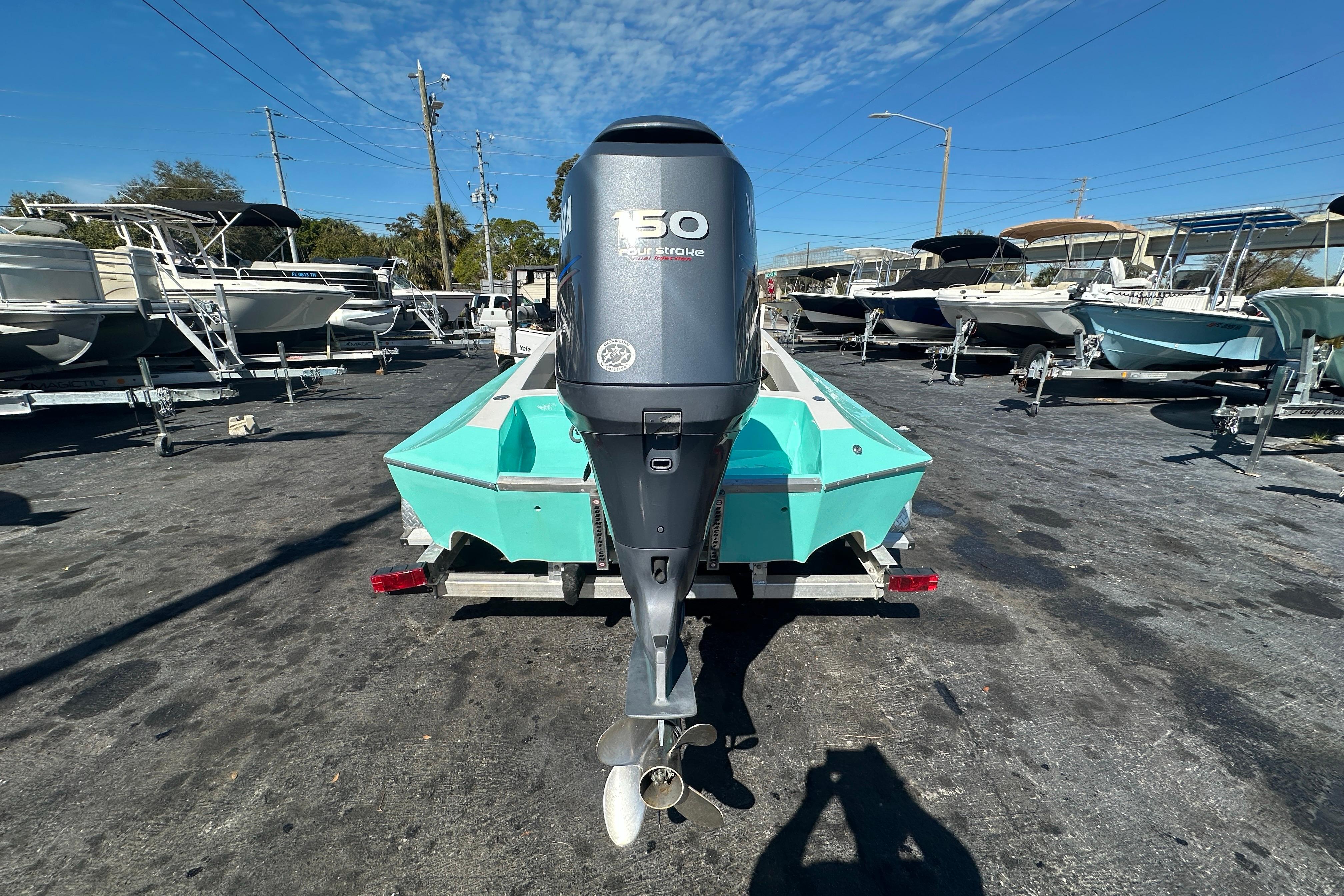 2022 Lightning 18 boat with 150 horsepower engine in a marina setting.