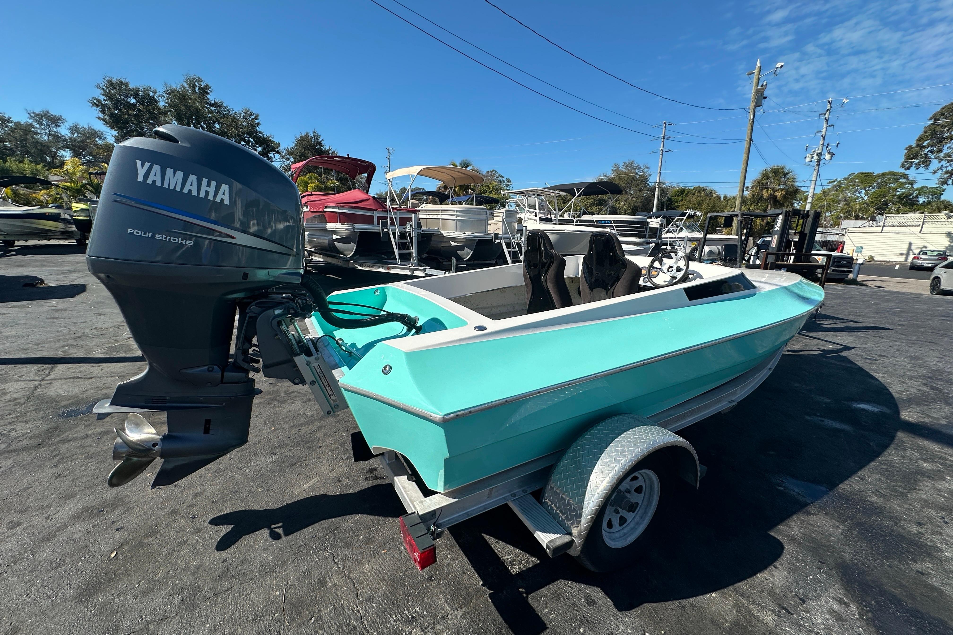 2022 Lightning 18 boat with Yamaha four-stroke engine, parked on a trailer.