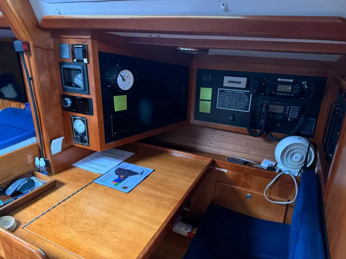 Harmony Yacht Photos Pics Navigation station inside a 2005 Tillotson-Pearson J-160 sailboat, featuring control panels and equipment.