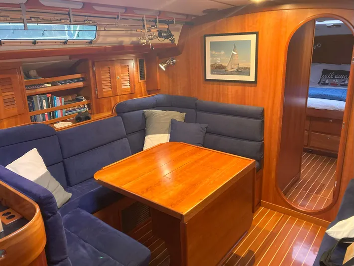 Harmony Yacht Photos Pics Luxurious 2005 Tillotson-Pearson J-160 yacht interior with cozy seating and wooden finishes.