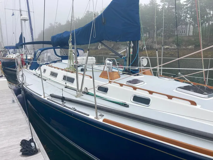 Harmony Yacht Photos Pics 2005 Tillotson-Pearson J-160 sailboat docked, featuring sleek design and blue hull.