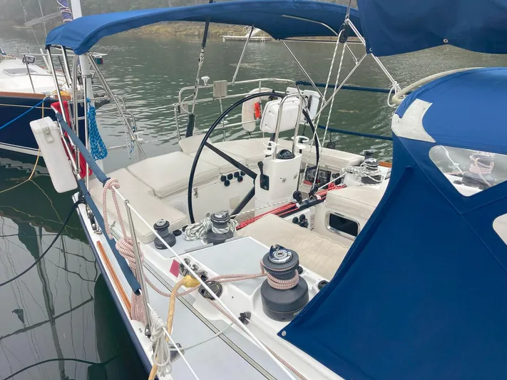 Harmony Yacht Photos Pics 2005 Tillotson-Pearson J-160 sailboat with blue canopy, docked in calm waters.