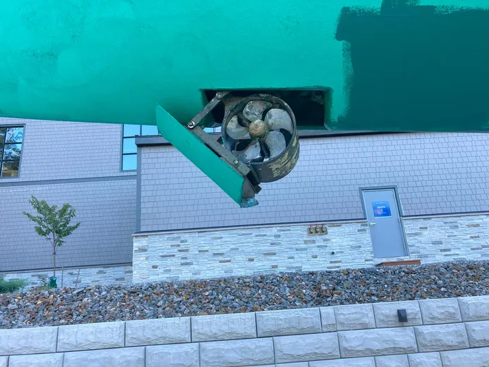 Harmony Yacht Photos Pics Underwater thruster of 2005 Tillotson-Pearson J-160 boat, displayed against a building backdrop.