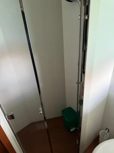  Yacht Photos Pics Compact shower area in a 2006 Pershing 56 yacht bathroom.