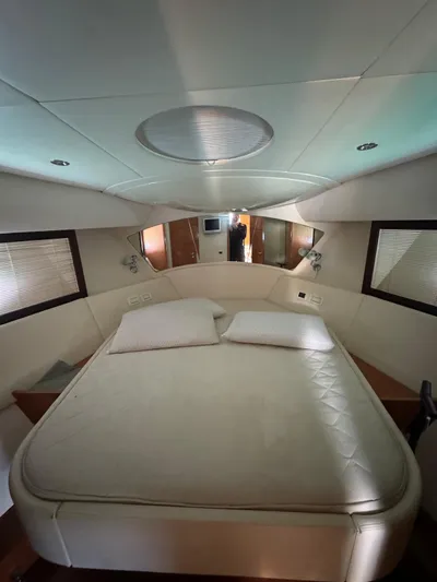  Yacht Photos Pics Luxurious bedroom interior of a 2006 Pershing 56 yacht, featuring a comfortable bed.