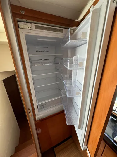  Yacht Photos Pics Open refrigerator inside a 2006 Pershing 56 yacht, featuring all-around cooling and adjustable shelves.