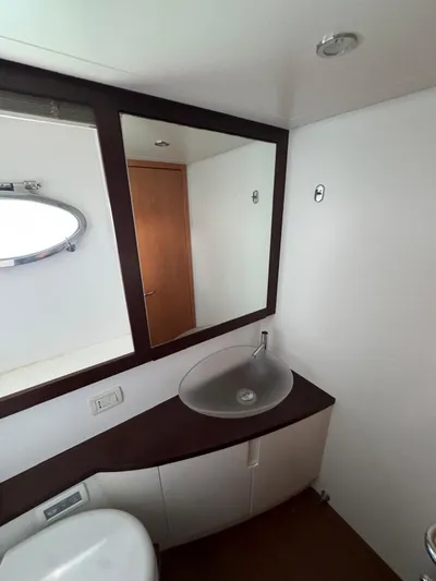  Yacht Photos Pics Bathroom interior of a 2006 Pershing 56 yacht, featuring a modern sink and mirror.