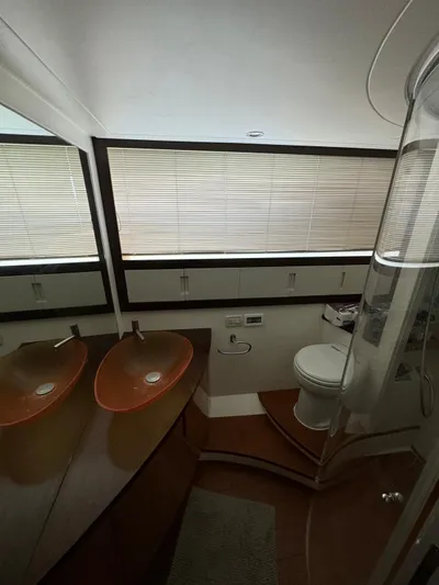  Yacht Photos Pics Luxurious bathroom interior of a 2006 Pershing 56 yacht with modern fixtures.