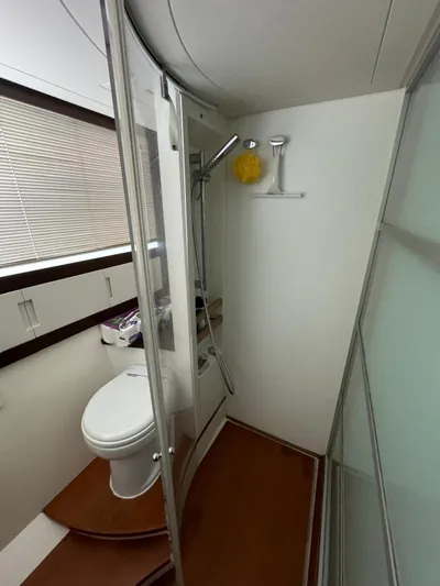  Yacht Photos Pics Bathroom interior of a 2006 Pershing 56 yacht, featuring a shower and toilet.