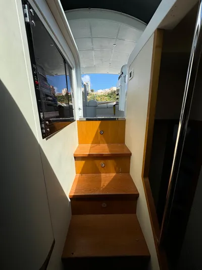  Yacht Photos Pics Interior stairs of a 2006 Pershing 56 yacht, leading to the deck.