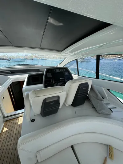  Yacht Photos Pics Interior view of 2006 Pershing 56 yacht cockpit with luxurious seating and navigation controls.