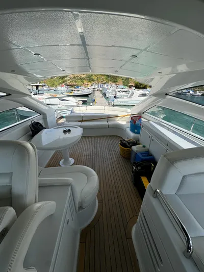  Yacht Photos Pics Luxurious 2006 Pershing 56 yacht interior with white seating and wooden flooring.