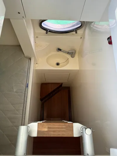  Yacht Photos Pics Interior of a 2006 Pershing 56 yacht, featuring a compact sink and wooden steps.