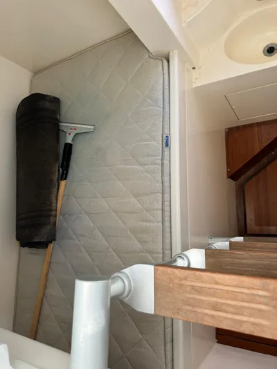  Yacht Photos Pics Storage area in a 2006 Pershing 56 yacht with cleaning tools and mattress.