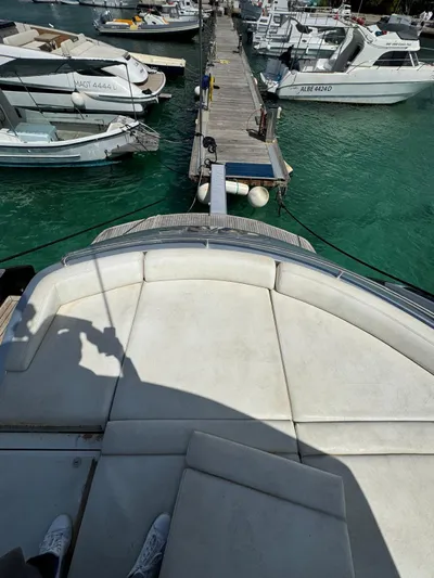  Yacht Photos Pics View from a 2006 Pershing 56 yacht docked at a marina with turquoise water.