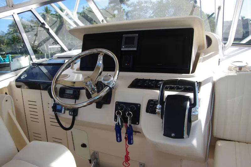 Kristy Lynn Yacht Photos Pics Helm of 2010 Grady-White Express 330 boat with steering wheel and controls.