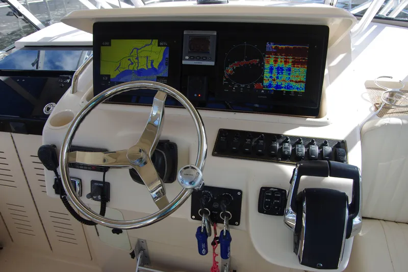 Kristy Lynn Yacht Photos Pics 2010 Grady-White Express 330 helm with navigation screens and steering wheel.