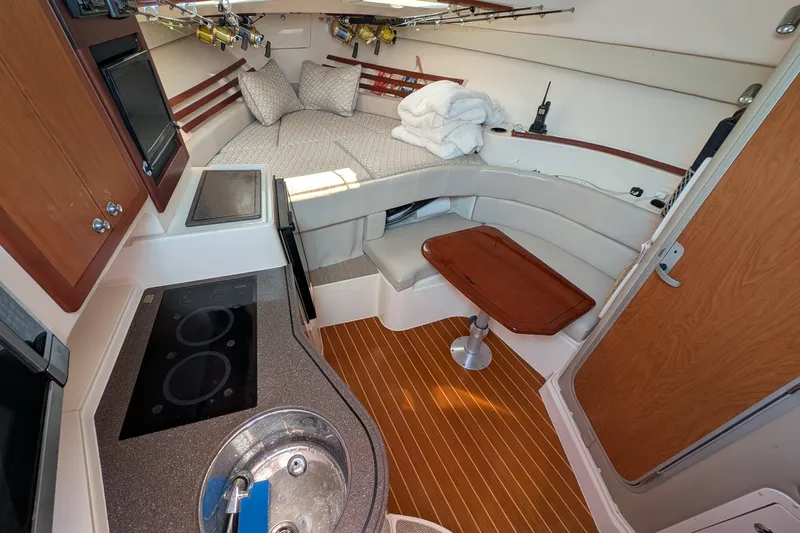 Kristy Lynn Yacht Photos Pics Interior of 2010 Grady-White Express 330 boat with kitchenette and cozy seating area.