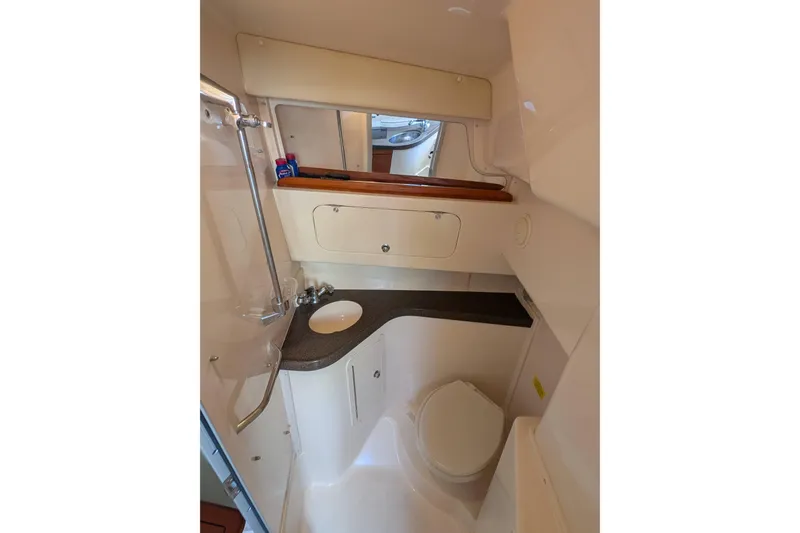 Kristy Lynn Yacht Photos Pics 2010 Grady-White Express 330 boat bathroom with sink, toilet, and storage cabinets.