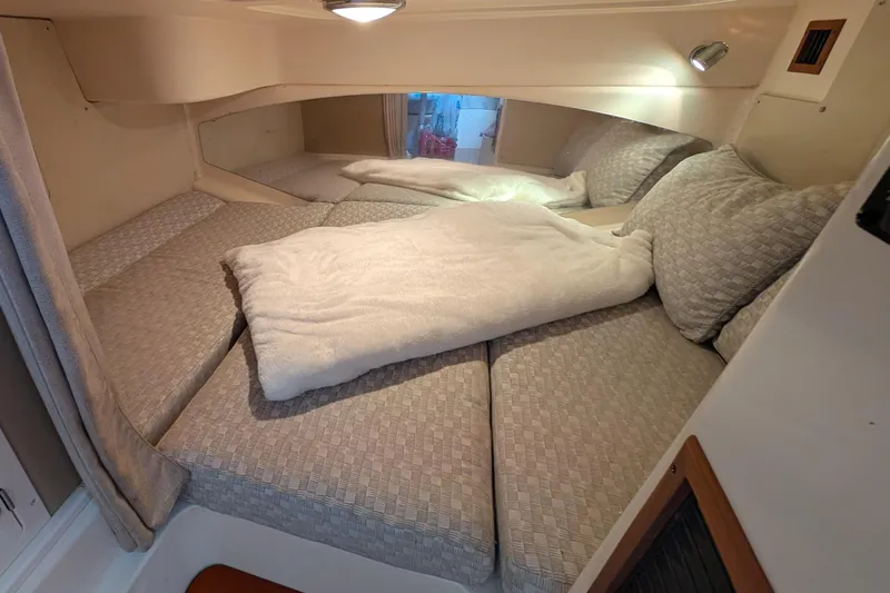 Kristy Lynn Yacht Photos Pics Cozy cabin interior of 2010 Grady-White Express 330 with comfortable bedding.