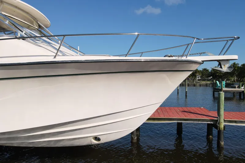 Kristy Lynn Yacht Photos Pics 2010 Grady-White Express 330 boat docked by a pier on a sunny day.