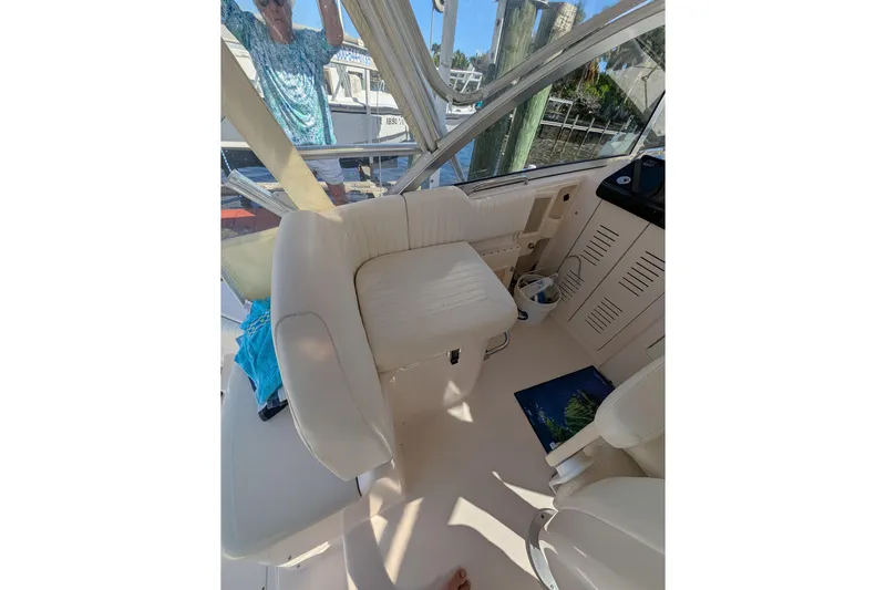 Kristy Lynn Yacht Photos Pics 2010 Grady-White Express 330 boat interior with white seating and helm area.