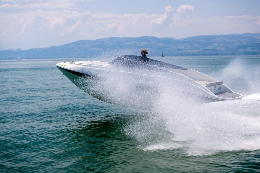 2023 Performance e801 speedboat skimming across water, creating a dynamic splash.