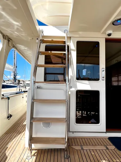  Yacht Photos Pics Staircase on 1996 Fleming 55 yacht with wooden steps and glass doors.