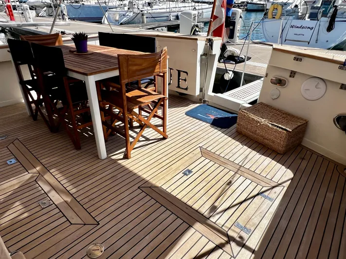  Yacht Photos Pics Deck of a 1996 Fleming 55 yacht with wooden flooring and outdoor seating.